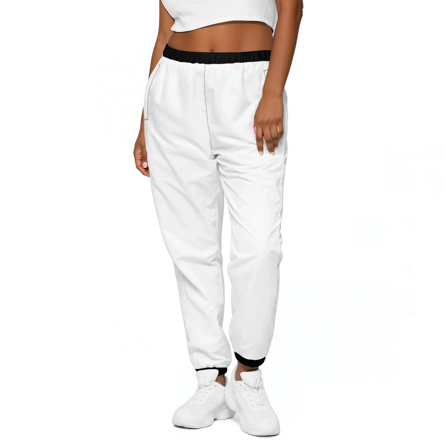 White Edition Track Pants worn with white sneakers, showcasing elastic ankle cuffs.