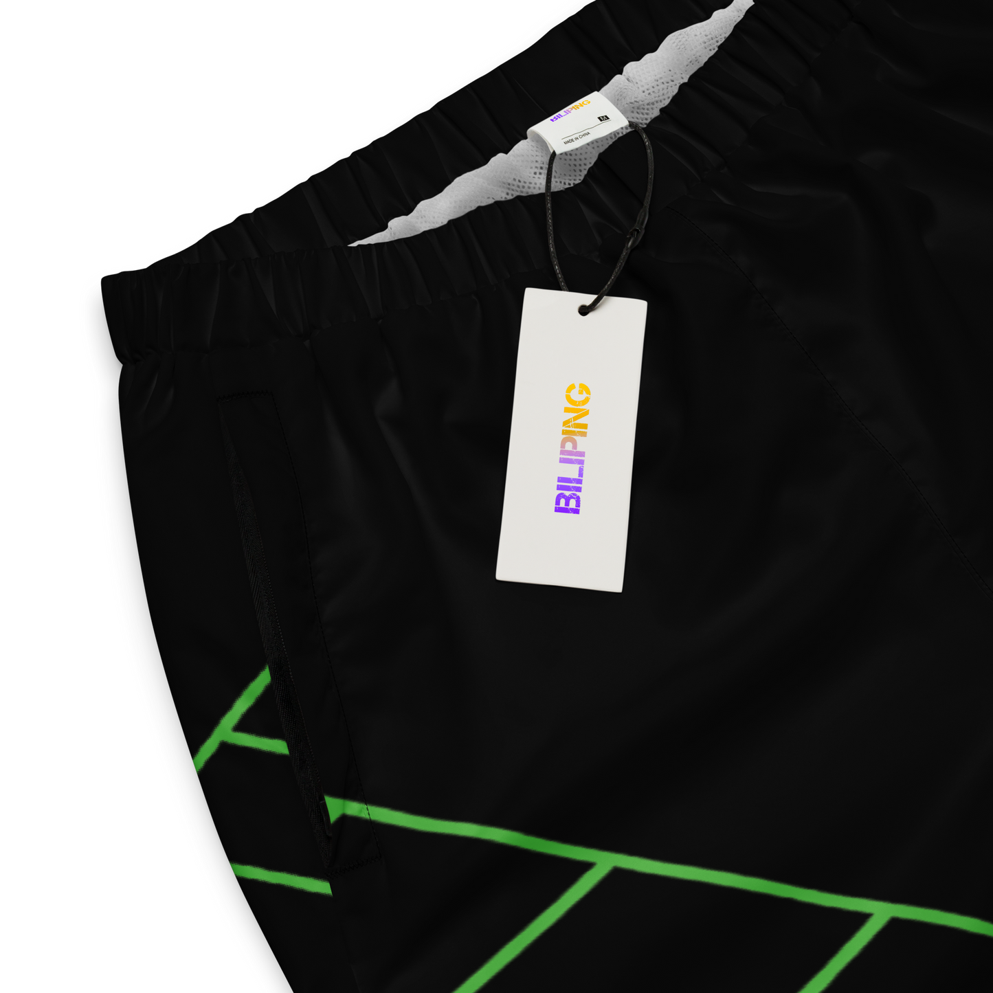 Everyday Essential Track Pants with tag on black shorts.