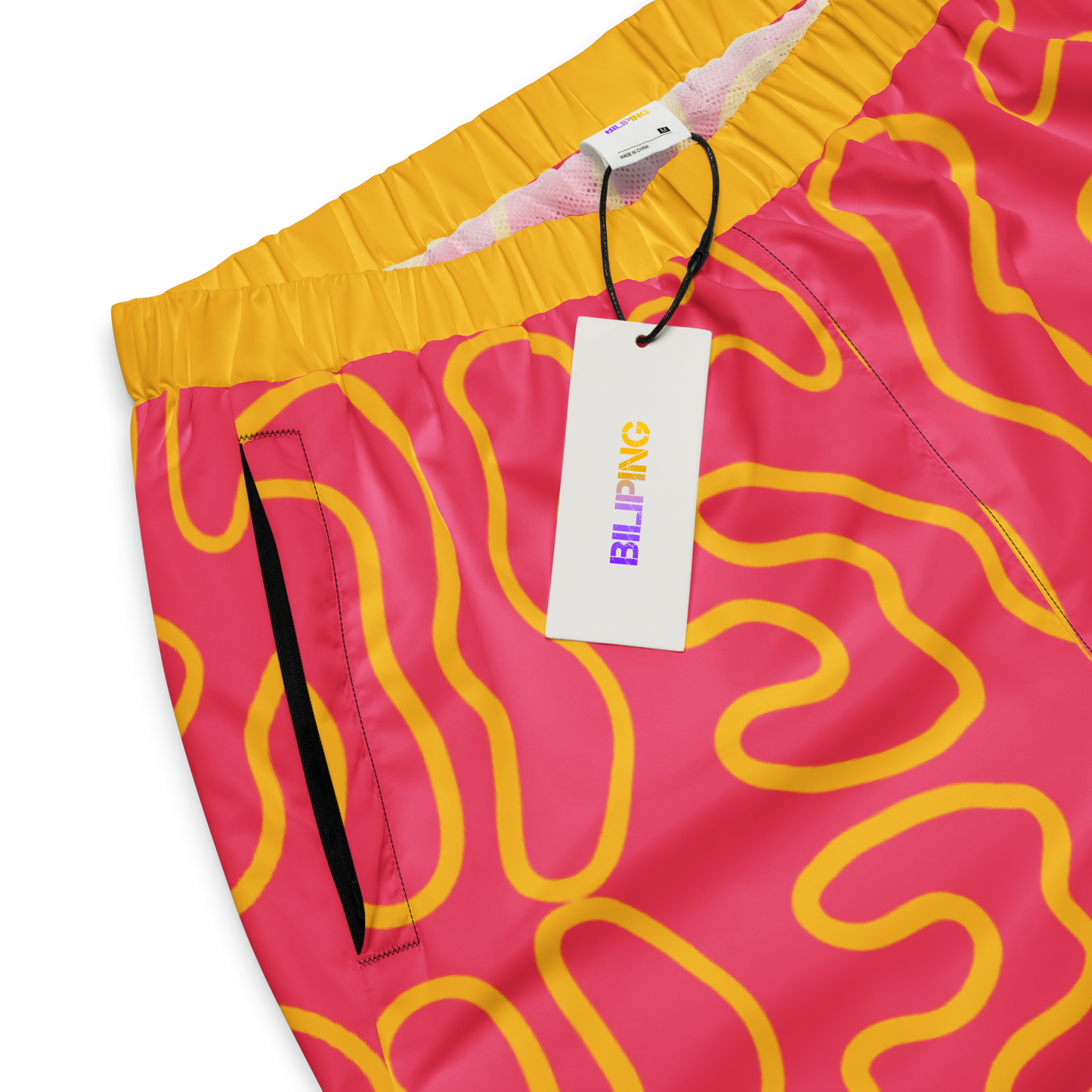 Wavy Line Track Pants with elastic cuffs and zip pockets.