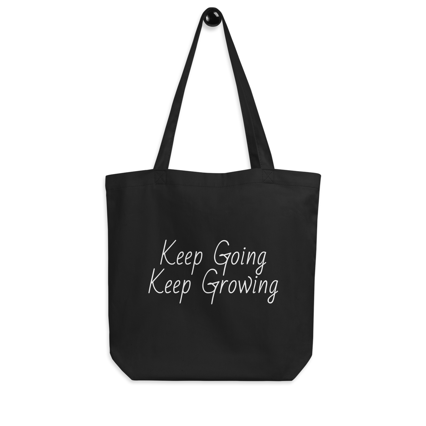 Black tote bag with Keep Going, Keep Growing in white text.