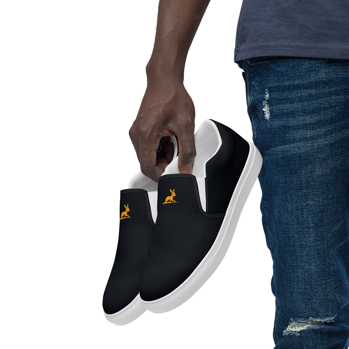 Biliping Canvas Slip-Ons held by person in denim trousers.