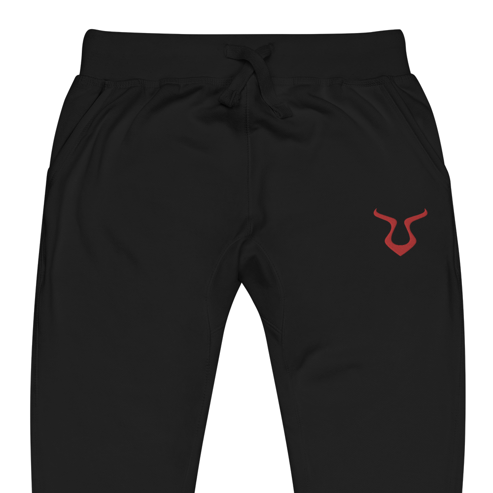 V - Sweatpants featuring a red logo, showcasing cuffed legs and elastic waistband.