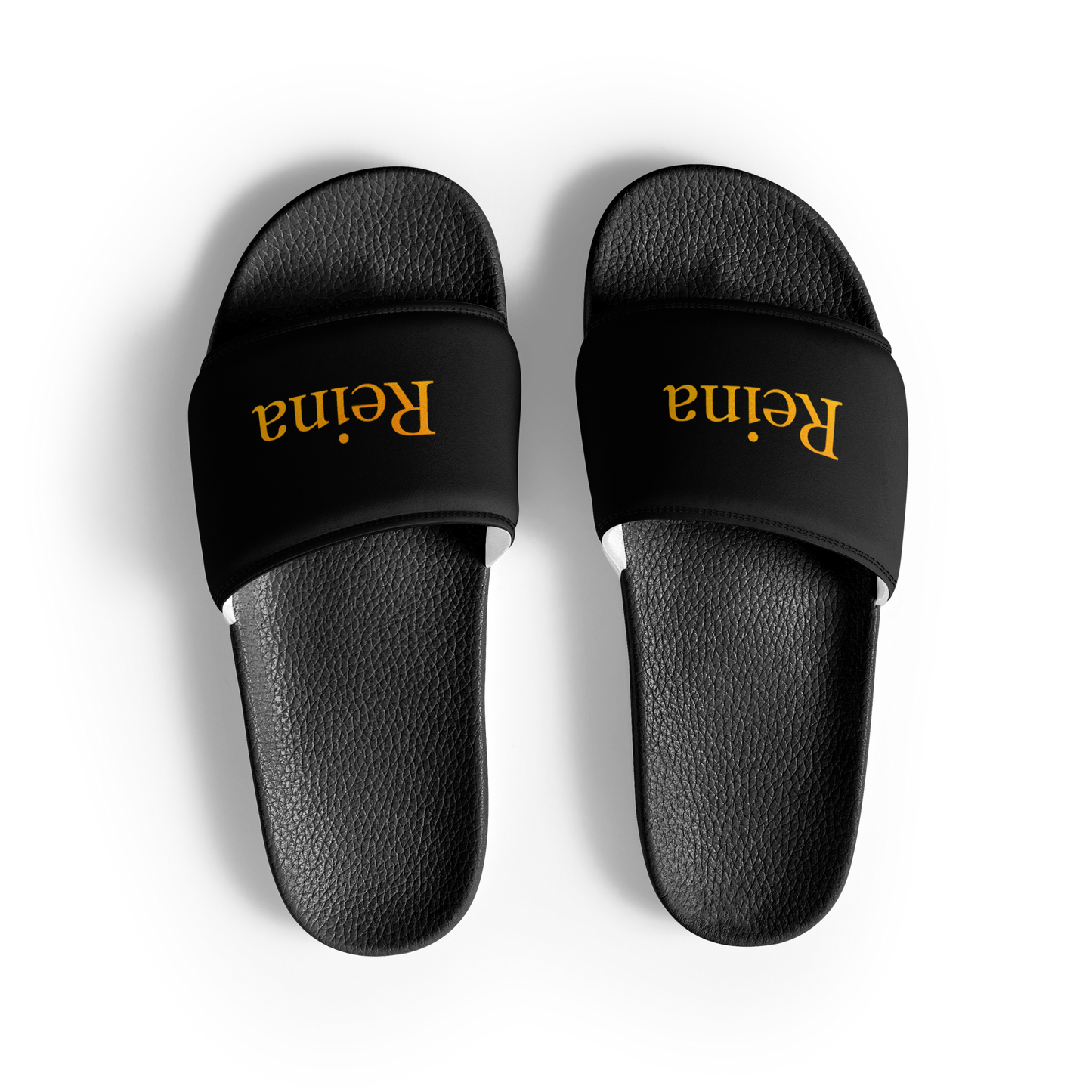 Reina black slippers with cushioned strap and contoured footbed.