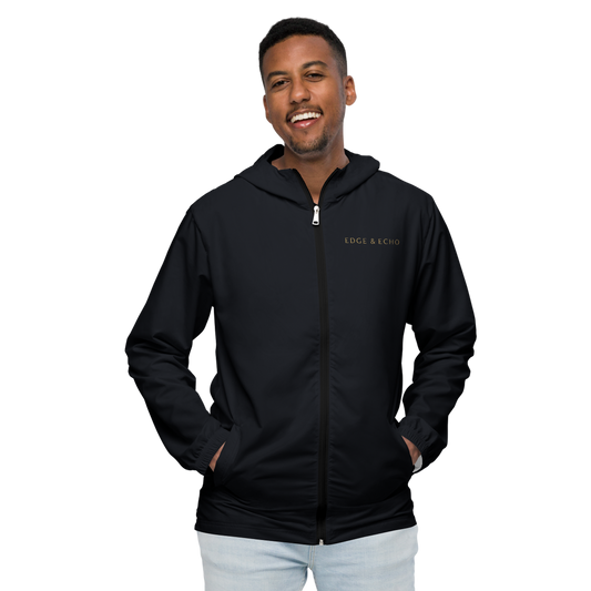 Man smiling while wearing the Edge & Echo Windbreaker.