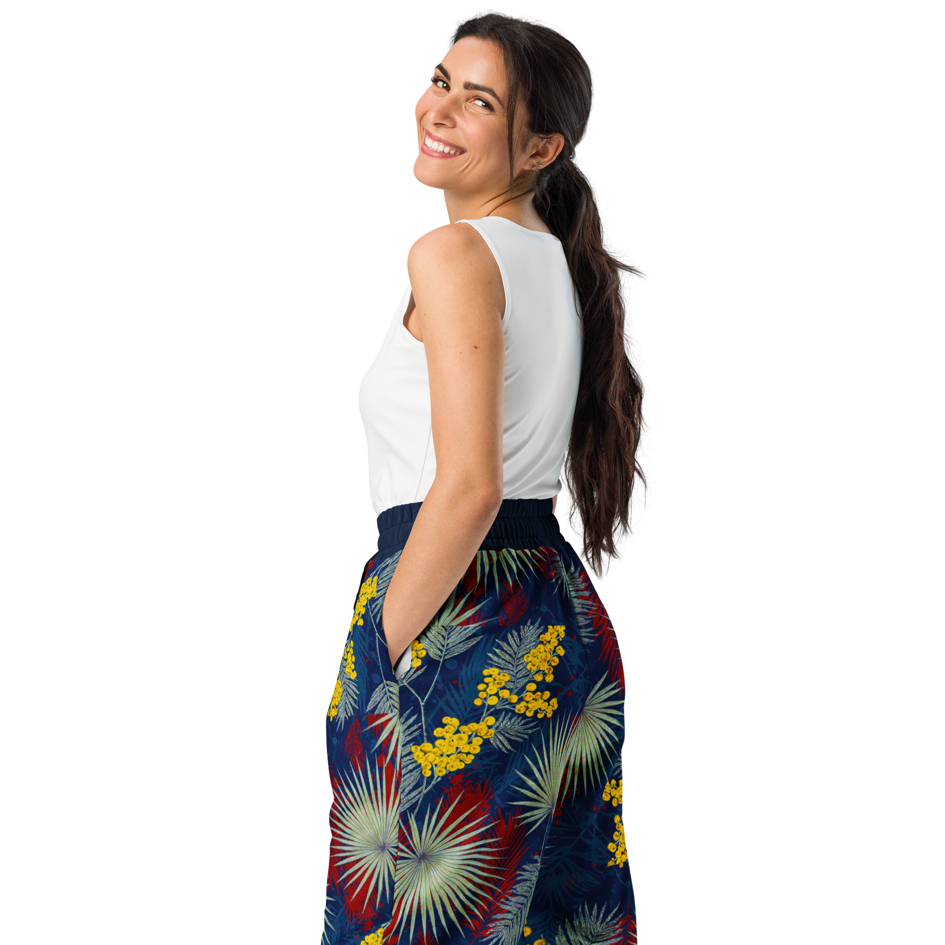 Woman smiling in wide-leg Mimosa Bloom Joggers, hands in pockets.